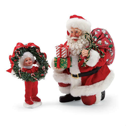beeldje van de knielende kerstman met een kind